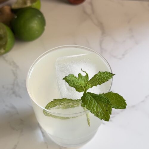 Mocktail mule with mint leaves and ice in a clear glass