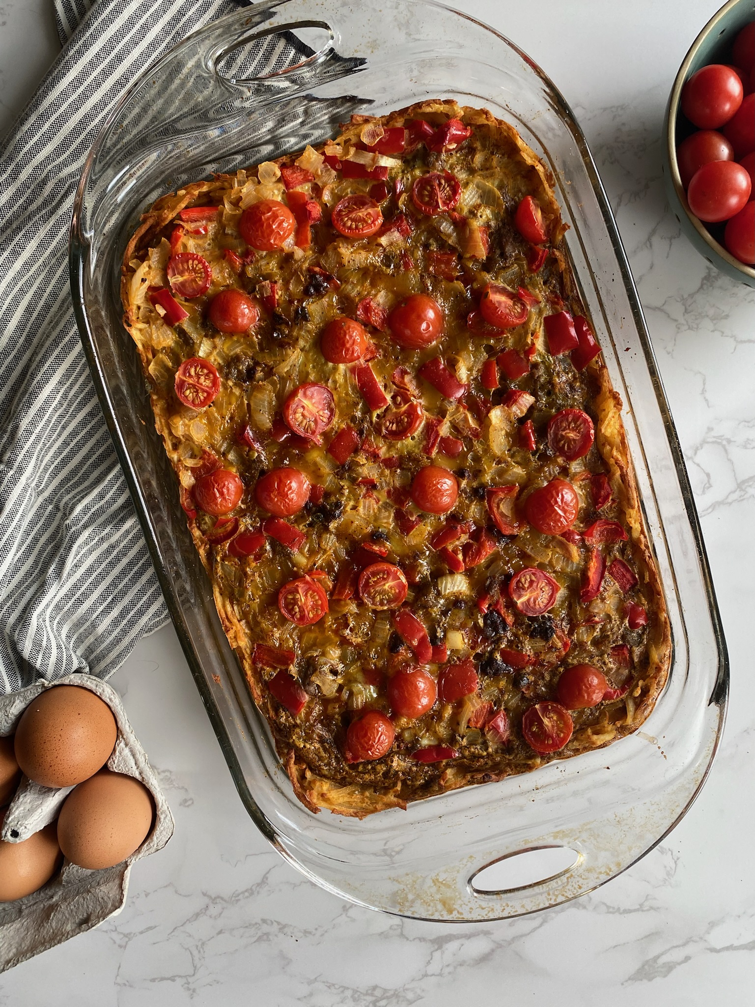 Potato crusted breakfast casserole in a glass baking dish