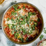 Mexican inspired brunch, topped with cilantro and cheese in a large pan