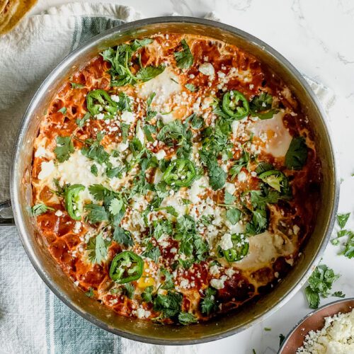 Mexican inspired brunch, topped with cilantro and cheese in a large pan