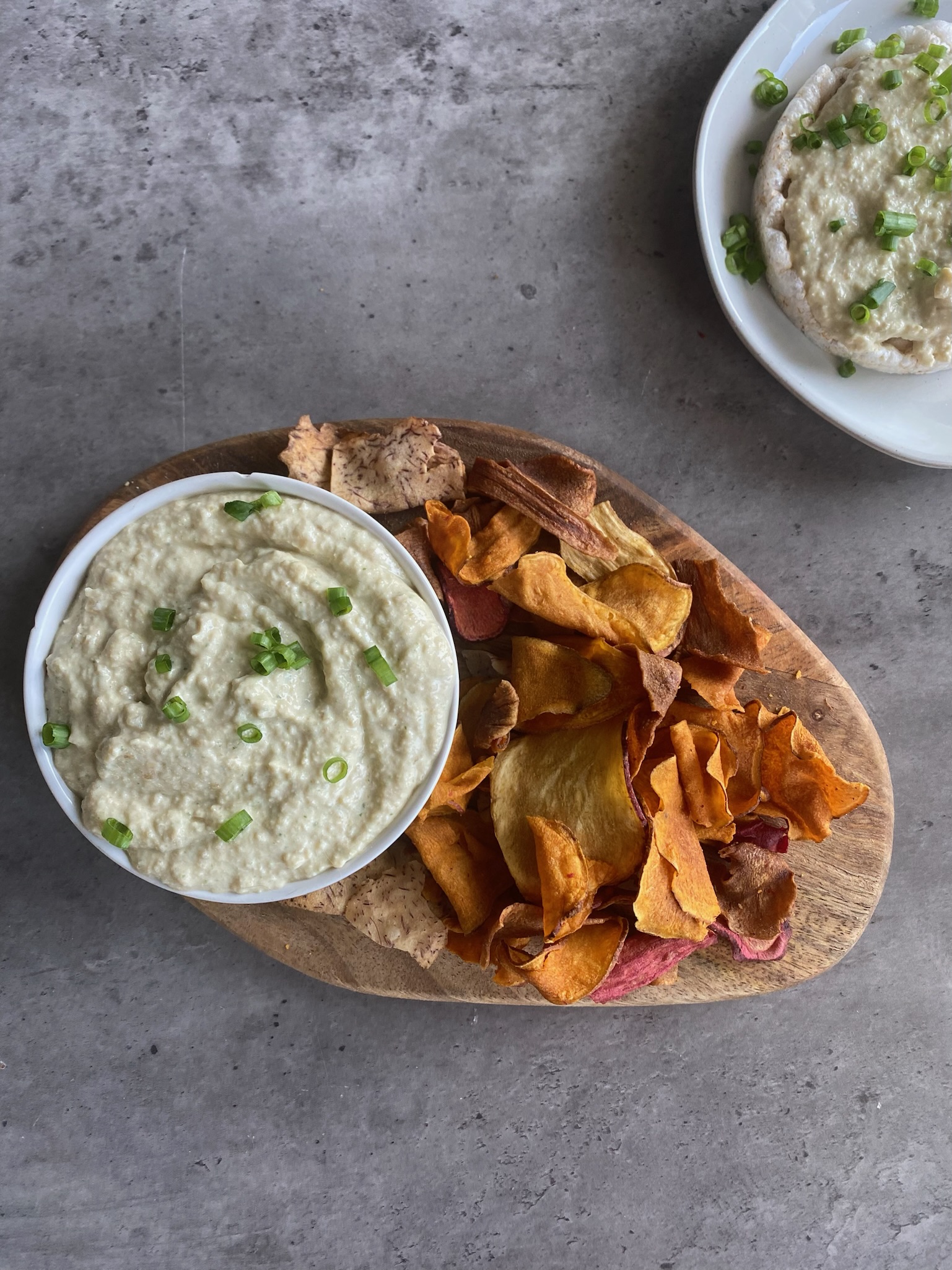 French onion dip with chips on a wooden platter