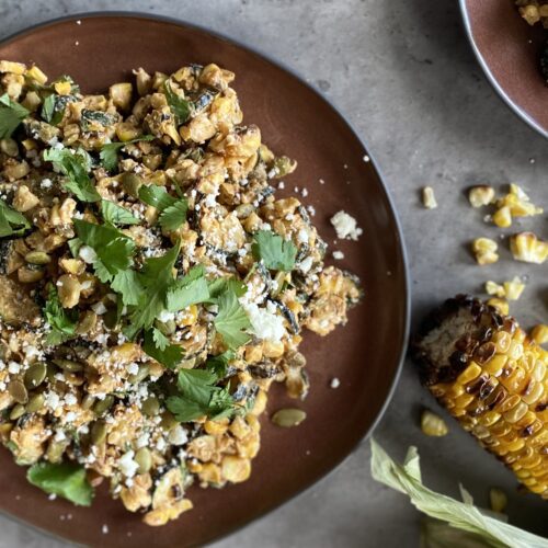 Grilled elotes salad with cilantro and feta on a plate