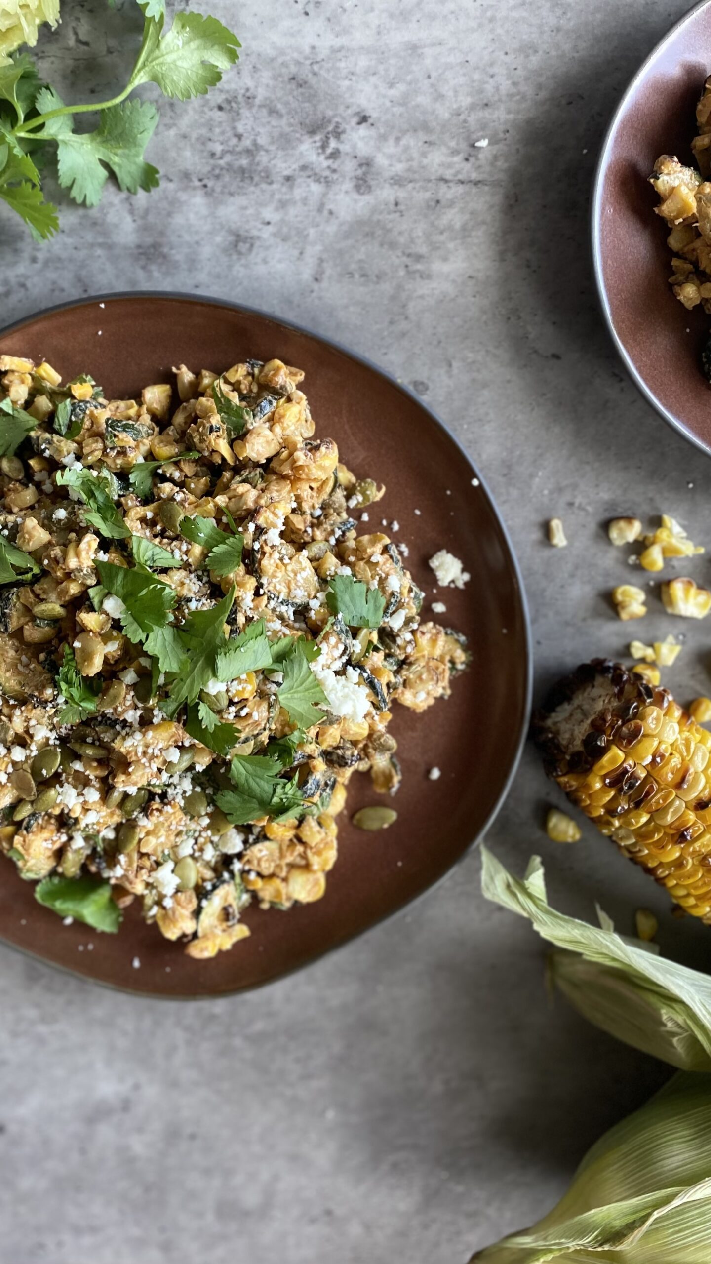 Grilled elotes salad with cilantro and feta on a plate